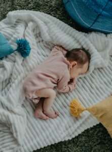 A sleeping newborn in a crib